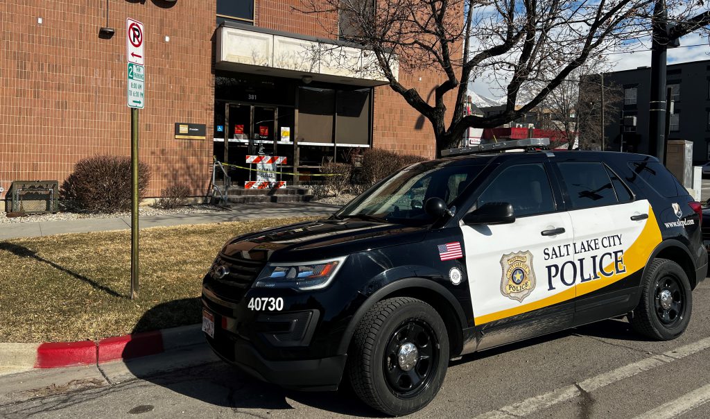 Photo of police car in front of a building.
