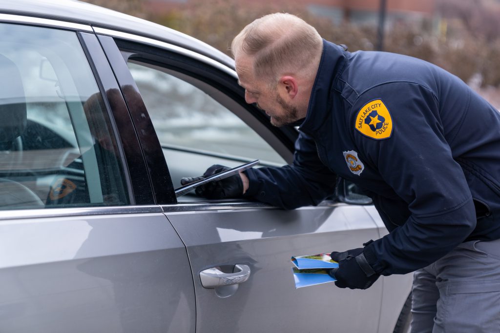 A police officer handing out free gun locks during a buy-back event at the Public Safety Building.